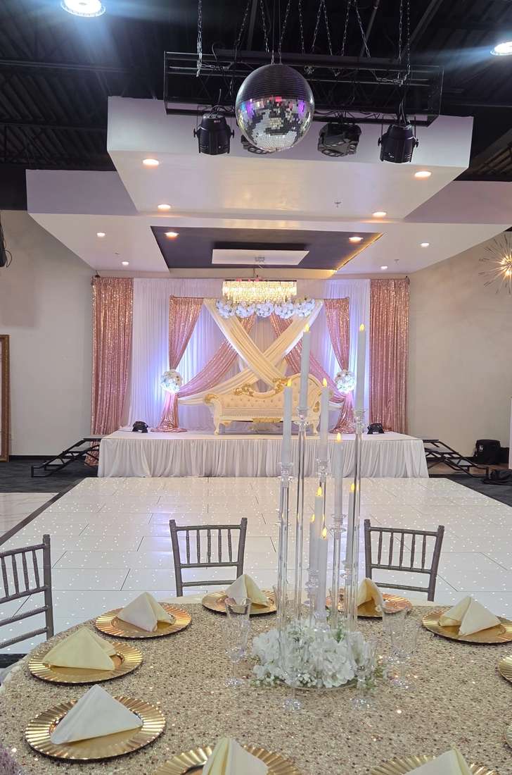 Champagne and rose-gold sequin stage with a gold throne sofa under a crystal chandelier at Silverstar Event Center in Lewisville, TX