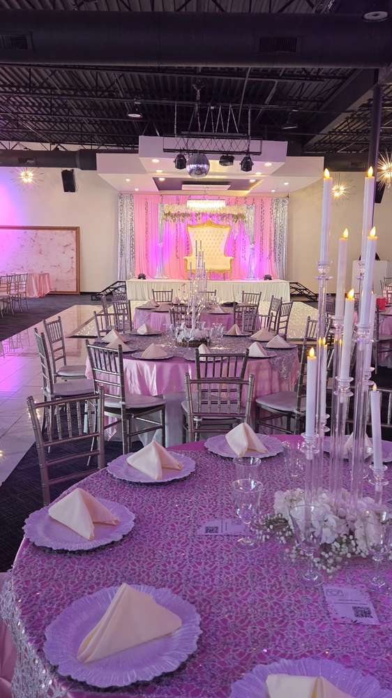 A full room of round tables in lilac lace and pink satin with silver Chiavari chairs at Silverstar Event Center in Lewisville, TX